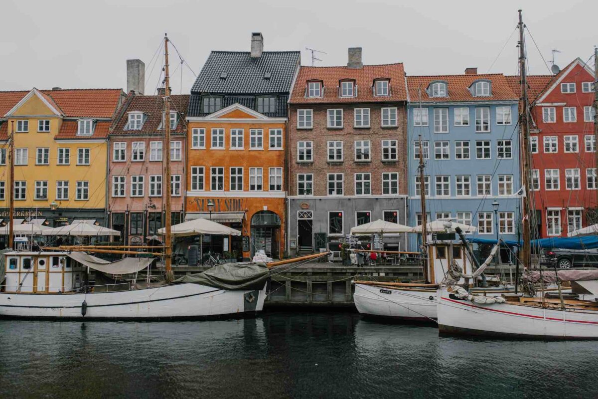 Nyhavn the tourist part of Copenhagen with brightly coloured house next to the harbour district